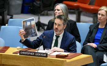 MSF’s Christopher Lockyear holds up an image of the destroyed MSF shelter in Al-Mawasi in Khan Younis, Gaza. Attacks on medical care are devastating